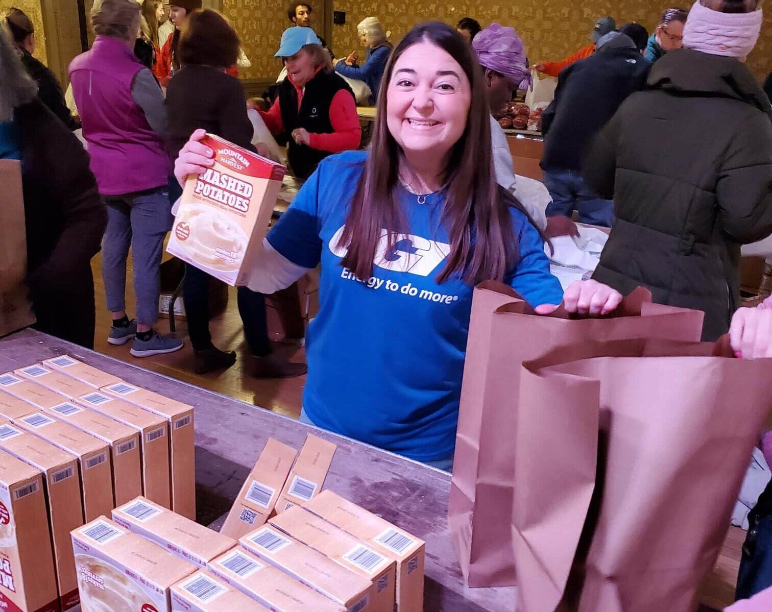 UGI employee packs food for distribution to community.