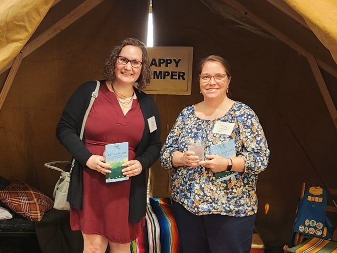 Jena and another employee at a volunteer event