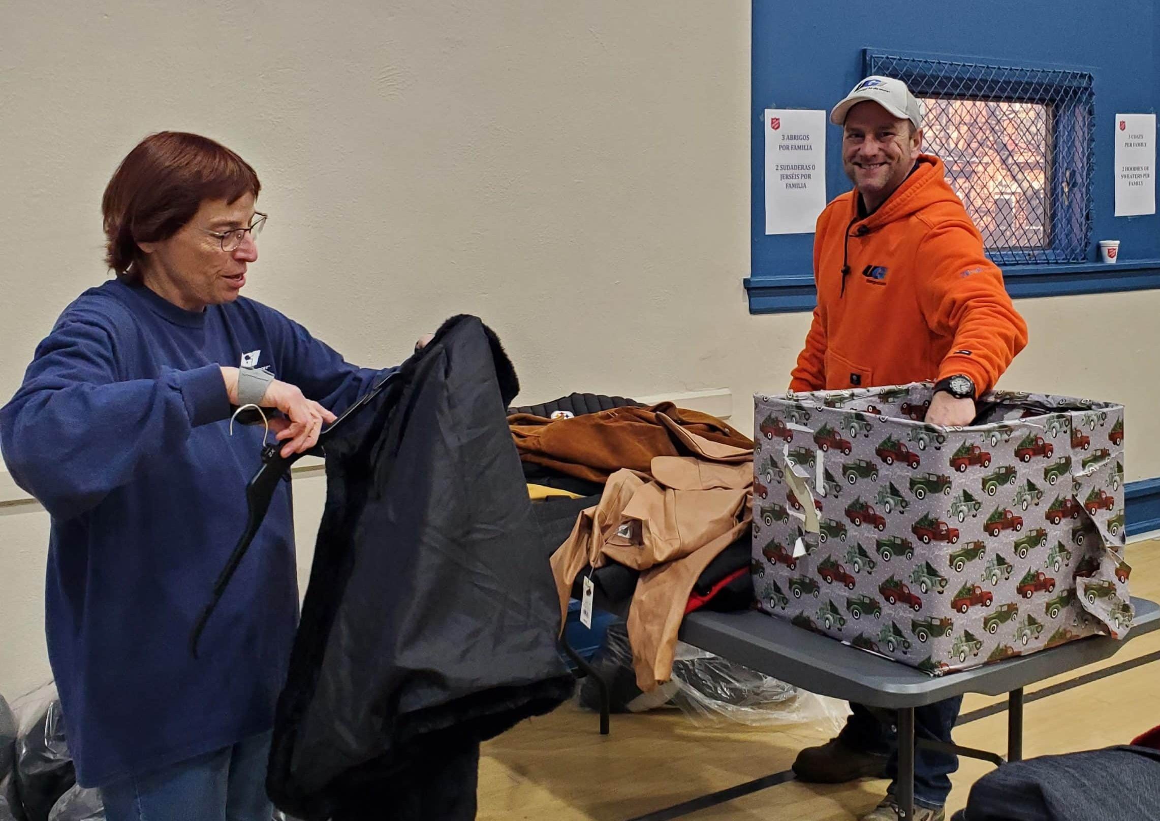 UGI employees putting coats on hangers.