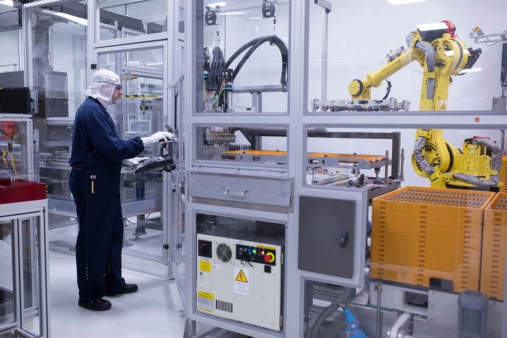 A worker inside a medicine and device manufacturing facility.